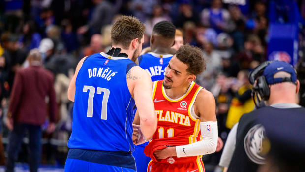 Mavericks guard Luka Doncic shakes hands with Hawks guard Trae Young.